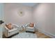 Basement sitting area with two chairs and small table at 3051 Maple Ln, Alpharetta, GA 30009