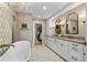 Elegant bathroom with double vanities, a large soaking tub, and a walk-in closet at 3051 Maple Ln, Alpharetta, GA 30009
