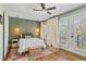 Charming bedroom with wood floors, sliding doors, and ceiling fan at 3051 Maple Ln, Alpharetta, GA 30009