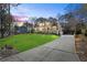 Two story home with large driveway and landscaping at 3051 Maple Ln, Alpharetta, GA 30009