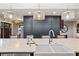 Kitchen with a large island, white sink, and modern light fixtures at 3051 Maple Ln, Alpharetta, GA 30009