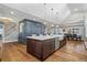 Open kitchen with hardwood floors, large island, and white cabinets at 3051 Maple Ln, Alpharetta, GA 30009
