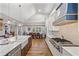 Bright kitchen with white cabinets, large island, and high ceilings at 3051 Maple Ln, Alpharetta, GA 30009