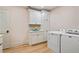 Bright laundry room with white cabinets and washer and dryer at 3051 Maple Ln, Alpharetta, GA 30009