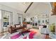 Living area with a leather sofa, hardwood floors, and views into the kitchen at 3051 Maple Ln, Alpharetta, GA 30009