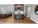 A home bar with wine storage and glass shelving at 3051 Maple Ln, Alpharetta, GA 30009
