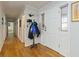 Long hallway with hardwood floors and coat rack at 911 Vistavia Cir, Decatur, GA 30033