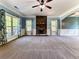 Open concept living room with stone fireplace and neutral carpet at 245 George Wynn Rd, Palmetto, GA 30268