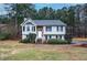 Two-story house with gray roof, stone accents, and landscaped yard at 90 Greatwood Dr, White, GA 30184