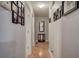 Bright hallway with hardwood floors and framed Gathering photos at 90 Greatwood Dr, White, GA 30184