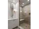 Stylish bathroom features a glass enclosed tiled shower, long mirror and modern lighting at 122 Gainey Ln, Chattahoochee Hills, GA 30268