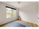 Bright bedroom featuring hardwood floors, a large window, and neutral walls, creating a serene and inviting atmosphere at 122 Gainey Ln, Chattahoochee Hills, GA 30268