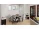 Cozy breakfast nook with three windows, a small round table, and four decorative chairs at 122 Gainey Ln, Chattahoochee Hills, GA 30268