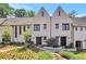 Stunning townhome showcasing manicured front yard, neutral paint, gabled roof, and dark framed windows at 122 Gainey Ln, Chattahoochee Hills, GA 30268