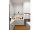 Updated kitchen featuring white subway tile backsplash, modern gray cabinets, and stainless steel appliances at 122 Gainey Ln, Chattahoochee Hills, GA 30268