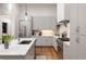 Bright kitchen with stainless steel appliances, marble countertop island, and hardwood floors at 122 Gainey Ln, Chattahoochee Hills, GA 30268