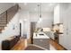 Bright kitchen with stainless steel appliances, marble countertop island, and hardwood floors at 122 Gainey Ln, Chattahoochee Hills, GA 30268