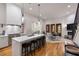 Modern open-concept kitchen with an island, bar stool seating, and stainless steel appliances at 122 Gainey Ln, Chattahoochee Hills, GA 30268