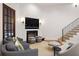 Cozy living room showcasing fireplace, comfortable seating, and stairs to the upper level at 122 Gainey Ln, Chattahoochee Hills, GA 30268