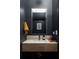 Stylish powder room with a granite counter, modern fixtures, and dark walls at 122 Gainey Ln, Chattahoochee Hills, GA 30268