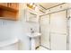 Clean bathroom with shower, sink, and wooden cabinets at 1836 Poinsetta Dr, Acworth, GA 30102