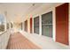 Covered porch with wooden railing and red shutters at 1836 Poinsetta Dr, Acworth, GA 30102