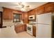 Kitchen with wood cabinets, white appliances, and an island at 1836 Poinsetta Dr, Acworth, GA 30102