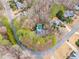 Aerial view of a secluded home with a private pool surrounded by lush greenery at 785 Charleston Dr, Roswell, GA 30075