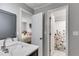 Well-lit bathroom with modern vanity and white-tiled shower, conveniently located near the bedroom at 785 Charleston Dr, Roswell, GA 30075