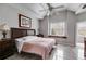 Bright and airy bedroom with tiled floors, natural light, and a decorative ceiling fan at 785 Charleston Dr, Roswell, GA 30075