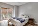 Cozy bedroom with a full-size bed, bedside table, and natural light from the window at 785 Charleston Dr, Roswell, GA 30075