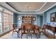 Elegant dining room with large windows, chandelier, wood floors, and classic furnishings at 785 Charleston Dr, Roswell, GA 30075