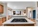Open-concept kitchen with island cooktop and view into an adjacent living space at 785 Charleston Dr, Roswell, GA 30075