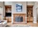 Comfortable living room area with a brick fireplace and built-in shelving on either side at 785 Charleston Dr, Roswell, GA 30075