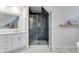 Modern bathroom featuring a frameless shower, white cabinets, and a spacious layout at 785 Charleston Dr, Roswell, GA 30075