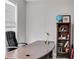 Home office with a dark desk, comfortable chair, and a bookshelf, creating a productive workspace at 785 Charleston Dr, Roswell, GA 30075