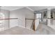 Spacious upstairs hallway with wood and white railings, leading to multiple rooms and a window at 785 Charleston Dr, Roswell, GA 30075