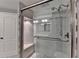 Glass-enclosed shower featuring built-in bench, and modern fixtures at 1379 Keys Lake Ne Dr, Brookhaven, GA 30319