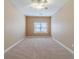 A bedroom featuring neutral walls, plush carpeting, and a window providing natural light at 3184 Islesworth Trce, Duluth, GA 30097
