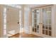Bright foyer features hardwood floors, a paneled front door, and French doors leading to another room at 3184 Islesworth Trce, Duluth, GA 30097