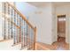 Hallway with hardwood floors, iron railing, and a view of the bathroom at 3184 Islesworth Trce, Duluth, GA 30097