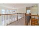 Open loft area overlooking the living room with views of backyard through large windows at 3184 Islesworth Trce, Duluth, GA 30097