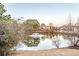 Pond with fountain and a distant view of upscale houses surrounded by trees at 3184 Islesworth Trce, Duluth, GA 30097