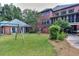 Green backyard with playground and partial home view at 619 Champions Dr, Mcdonough, GA 30253
