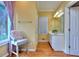 Bright bathroom with a vanity, window, and hardwood floors at 619 Champions Dr, Mcdonough, GA 30253