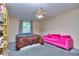 Bright bedroom with gray carpet and a pink couch at 619 Champions Dr, Mcdonough, GA 30253