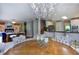 Spacious dining area with a large chandelier and hardwood floors at 619 Champions Dr, Mcdonough, GA 30253