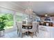 Bright dining area with round table, chandelier, and large windows at 619 Champions Dr, Mcdonough, GA 30253