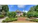 Brick home with manicured landscaping and large windows at 619 Champions Dr, Mcdonough, GA 30253