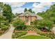 Brick home with landscaped yard and circular driveway at 619 Champions Dr, Mcdonough, GA 30253